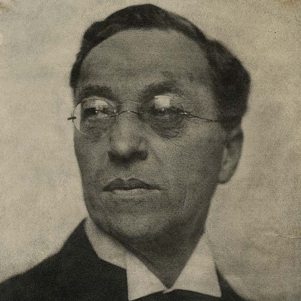 A portrait of Wassily Kandinsky in a suit and tie.